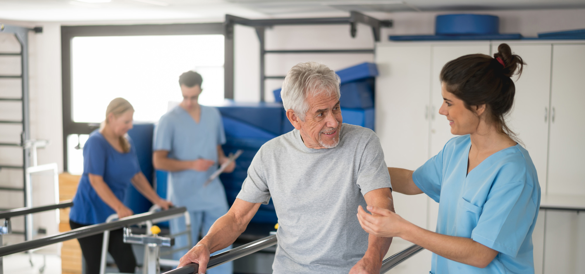 Physical therapist working with senior man.